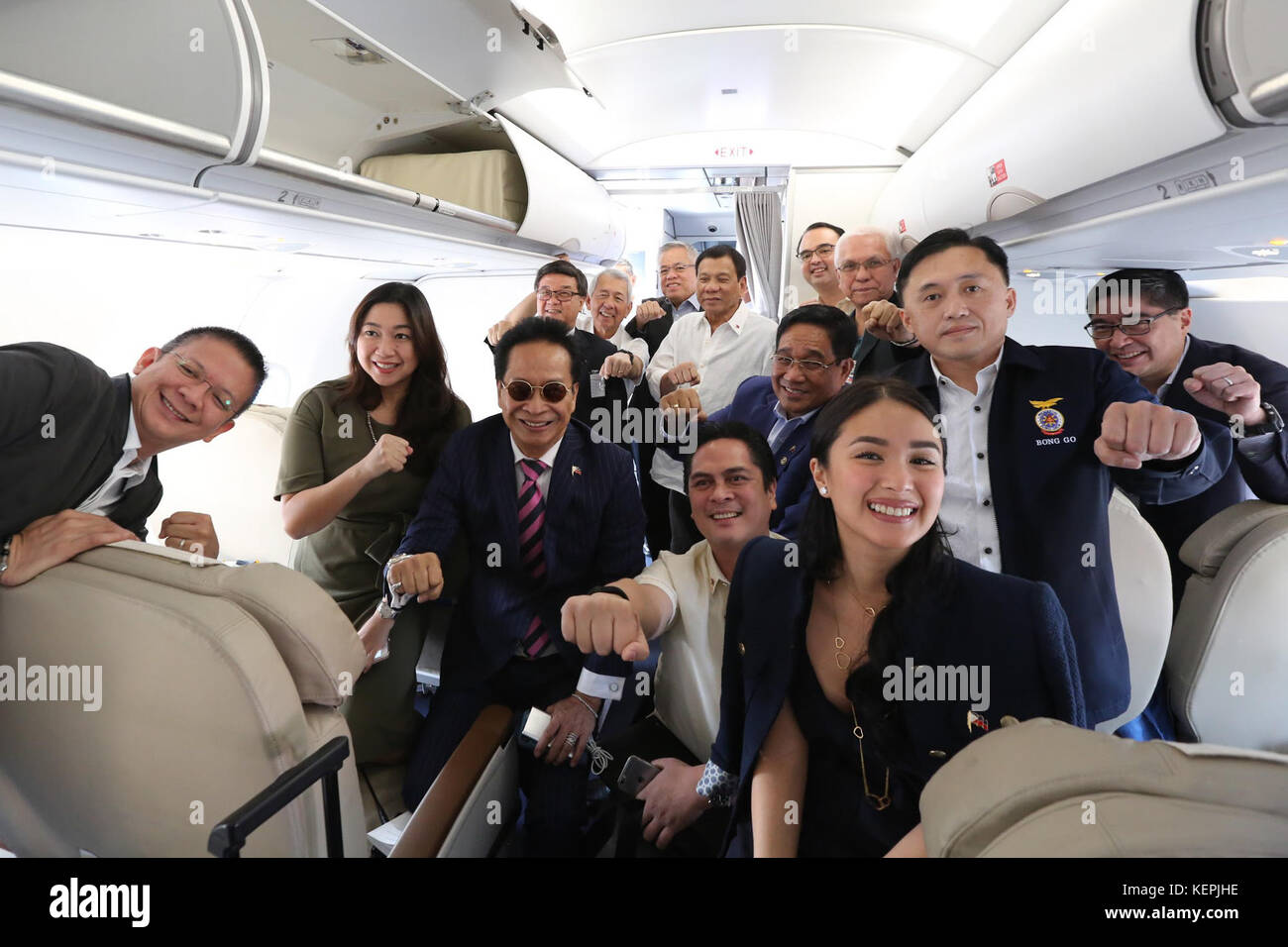 Rodrigo Duterte and his delegation pose for a photograph while on board Philippine Airlines bound for Vietnam on September 28 Stock Photo