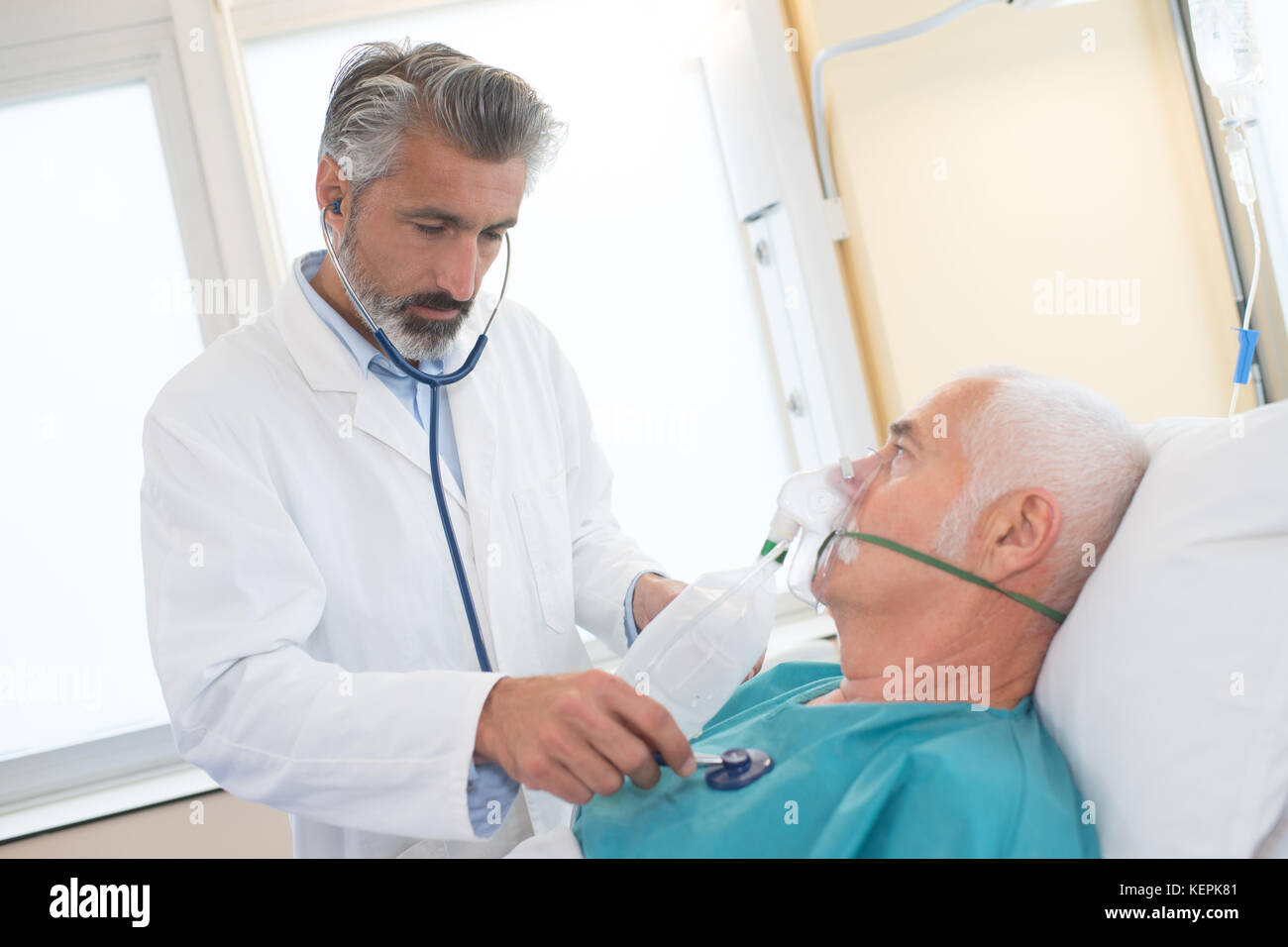 doctor checking on senior patient heart rate Stock Photo - Alamy