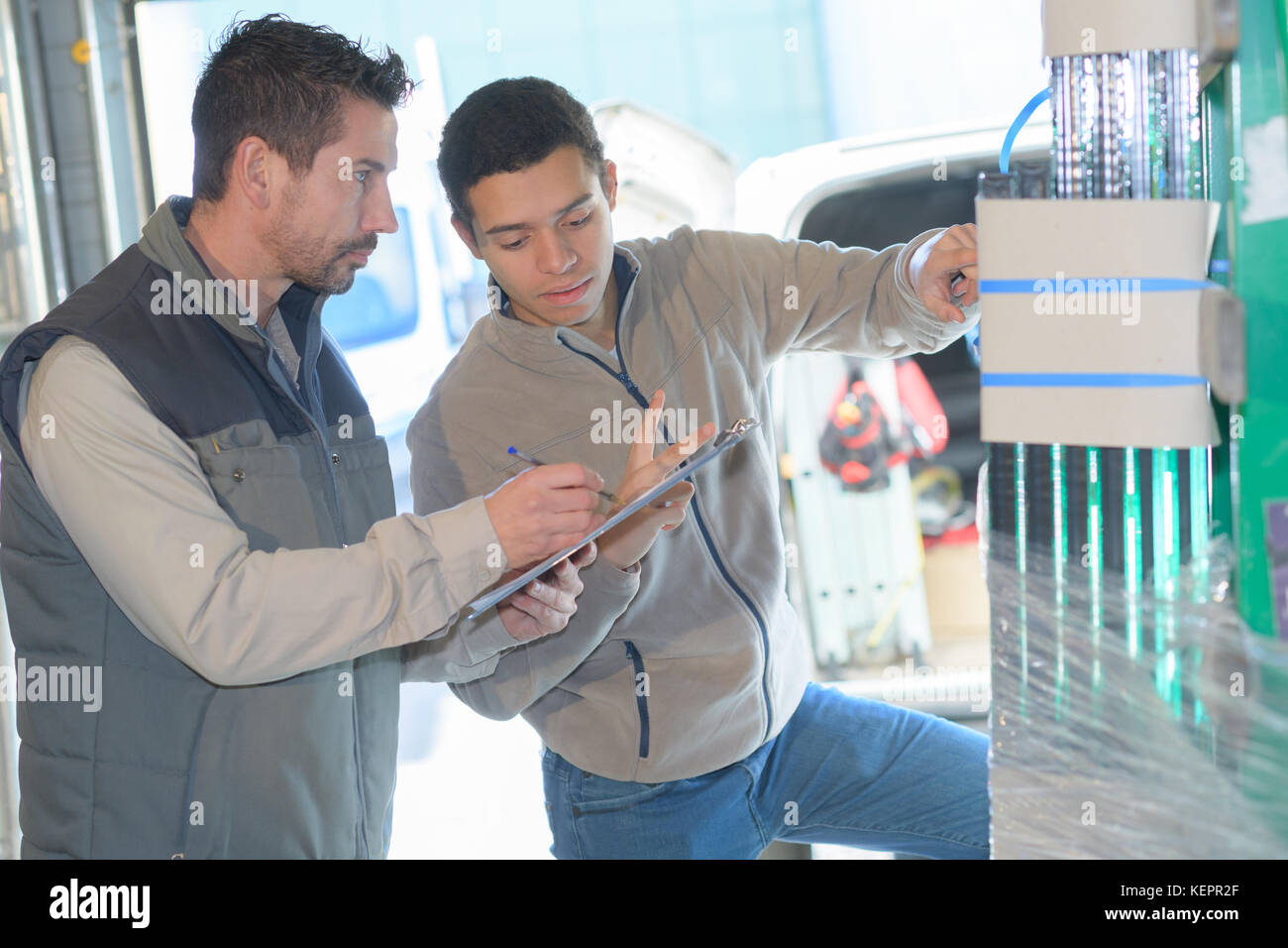 two worker in factory on the machine Stock Photo - Alamy