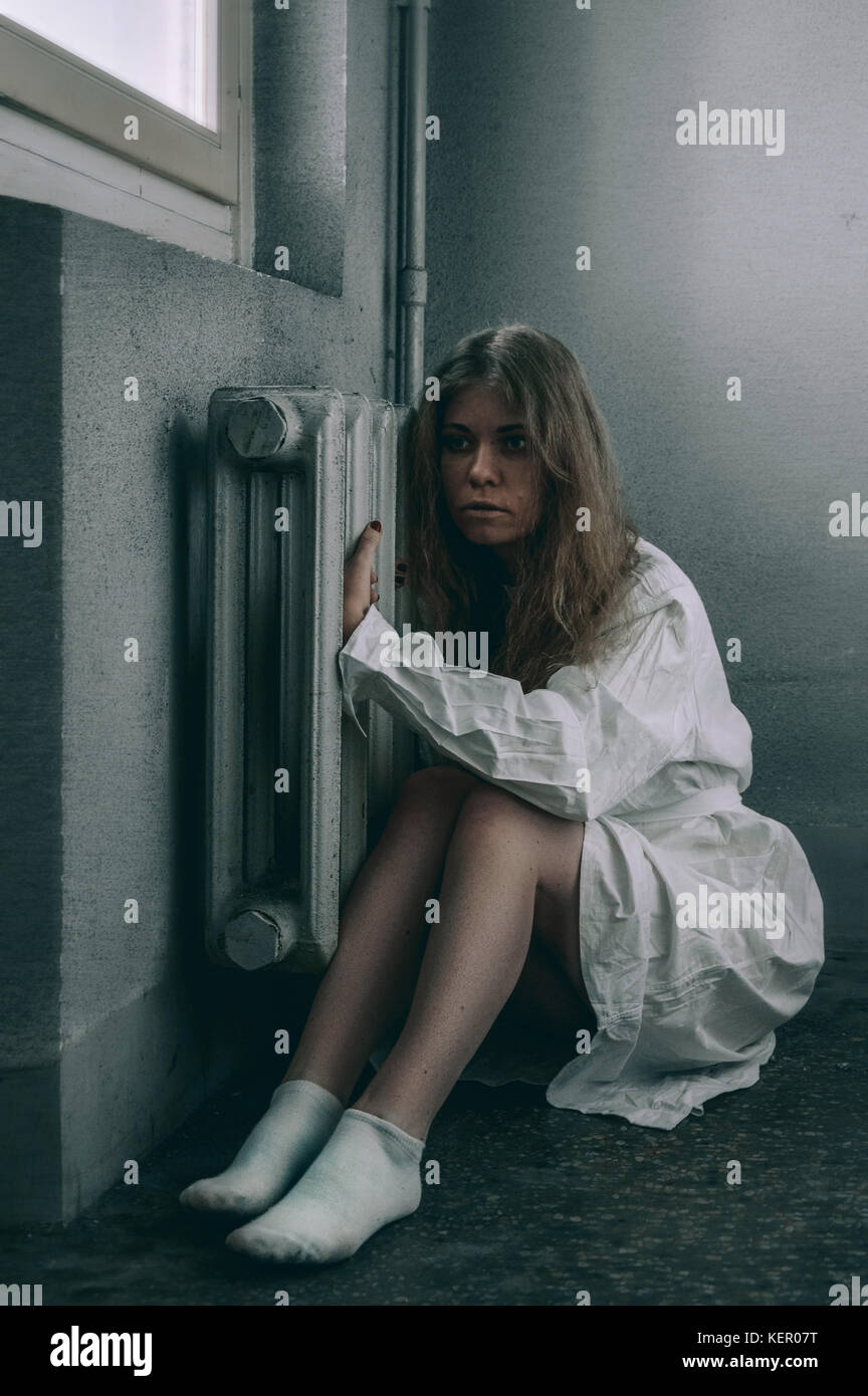 mentally ill girlwith a straitjacket in a Psychiatric Stock Photo