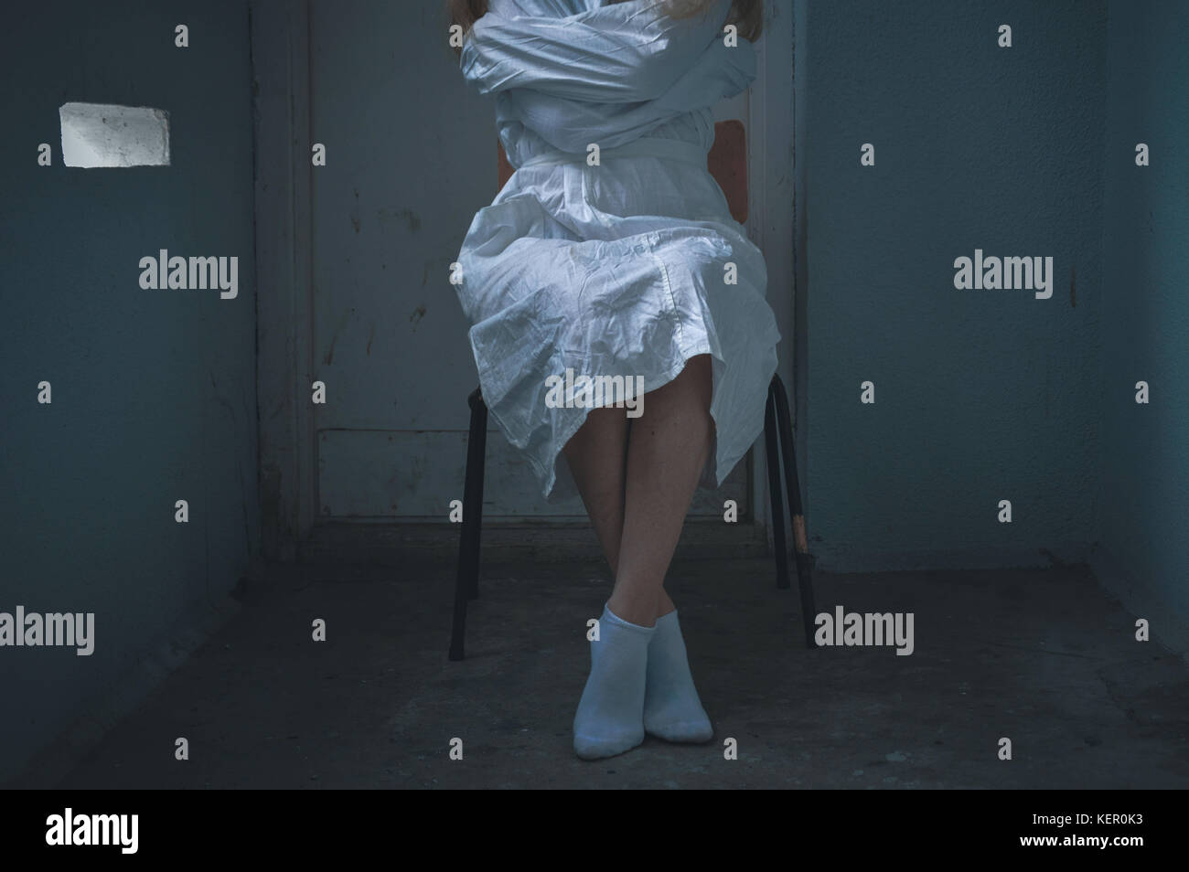 mentally ill girlwith a straitjacket in a Psychiatric Stock Photo