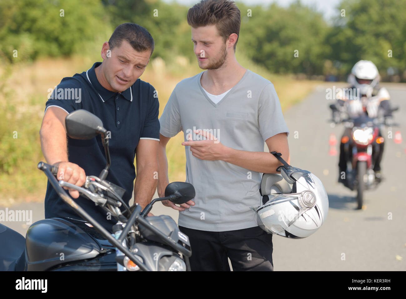 teacher and student on a motorbike test Stock Photo