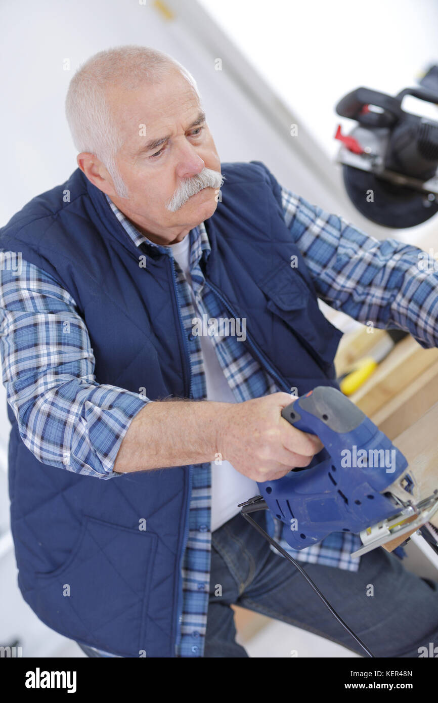 builder using a jigsaw to cut the plywood Stock Photo Alamy