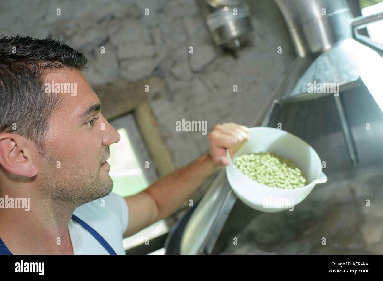 handsome brewer in uniform during brewing process Stock Photo Alamy