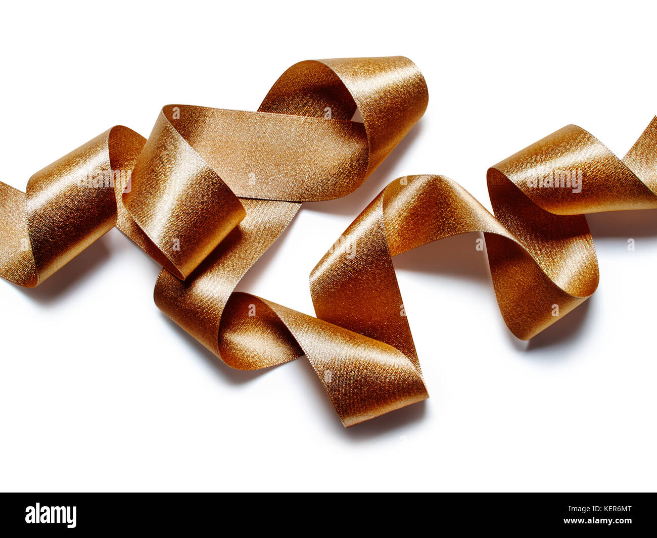 Close up of gold bronze metallic ribbon isolated on white background ...
