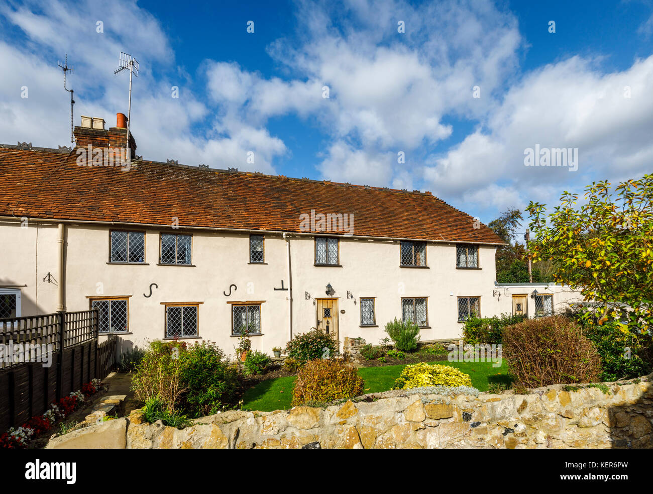 Charming country cottages with leaded light windows and wooden front door in Shalford, a village