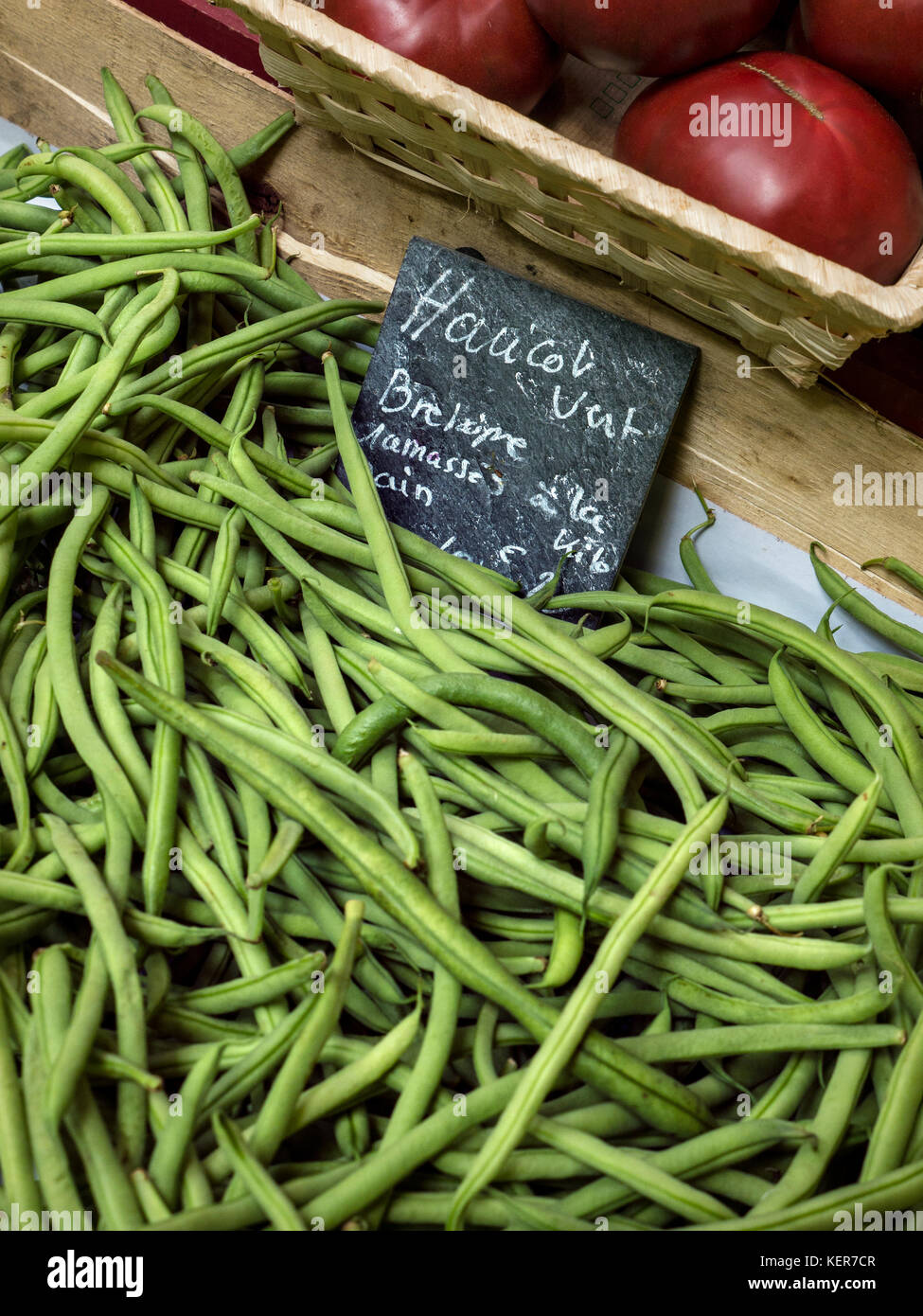 HARICOTS VERT GREEN BEANS Thin green raw French beans on sale with blackboard slate name tag displayed at Quimper market Brittany France Stock Photo