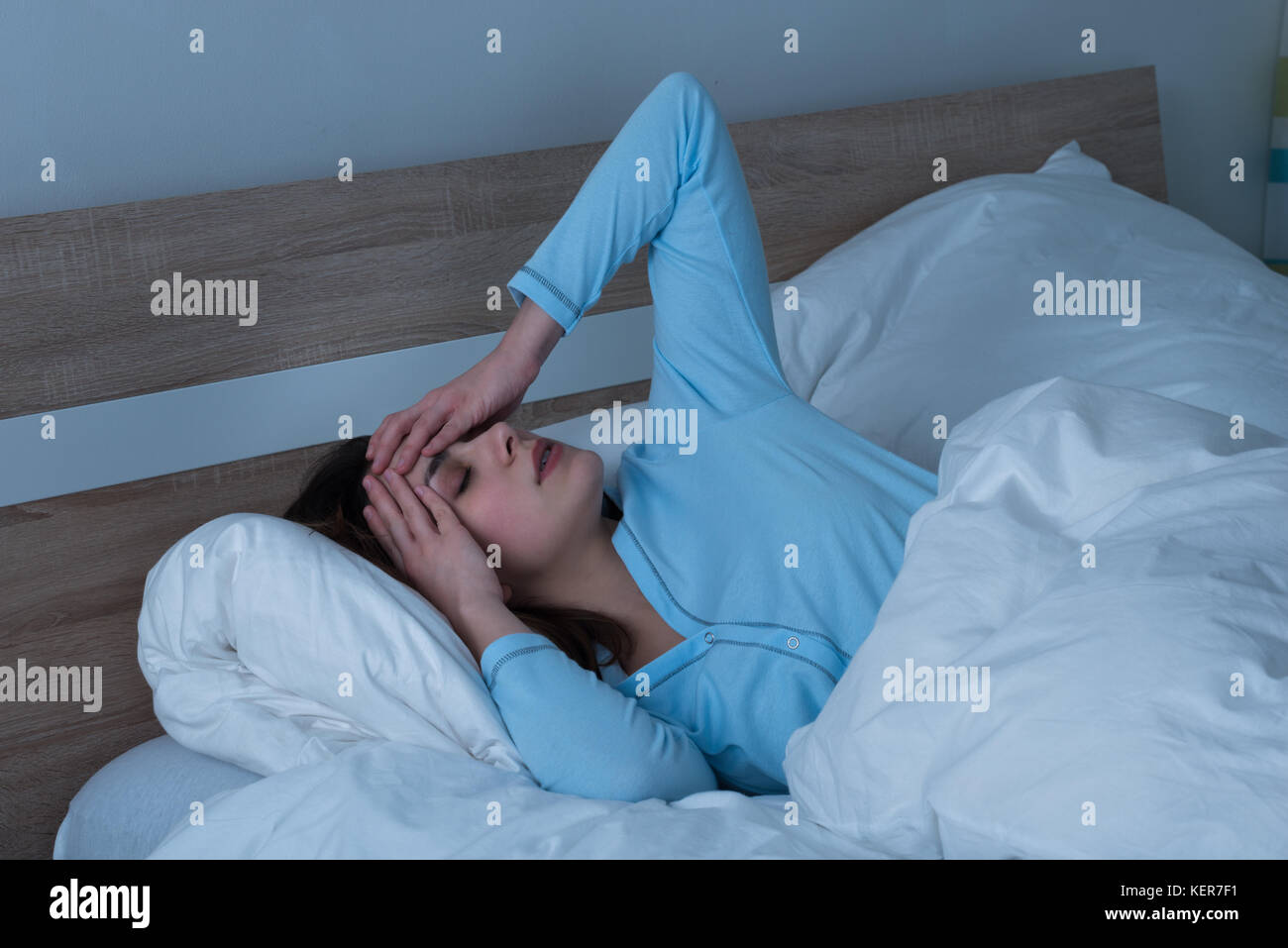 Young Woman Suffering From Headache Lying On Bed Stock Photo Alamy