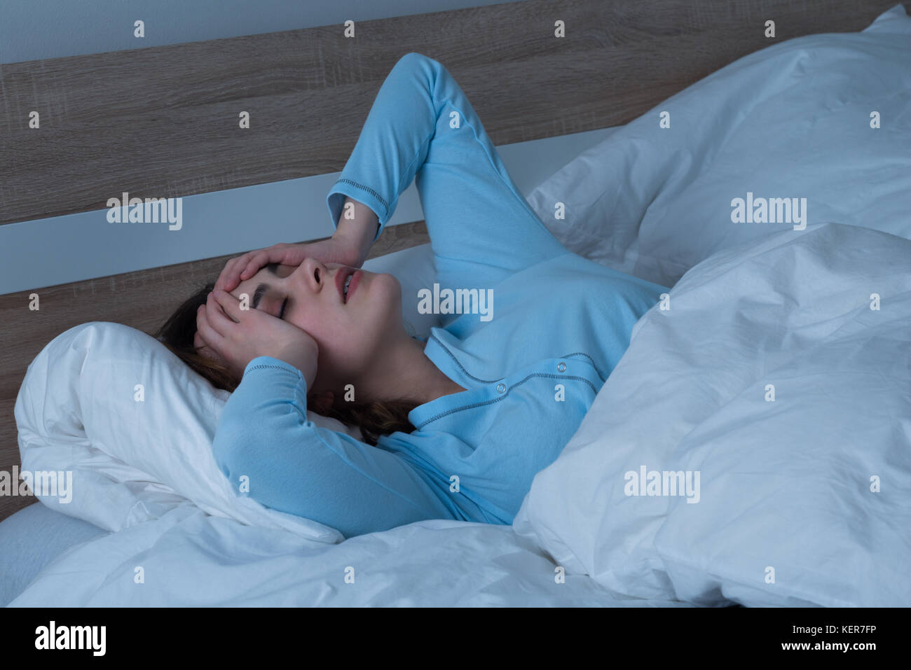 Young Woman Suffering From Headache Lying On Bed Stock Photo Alamy