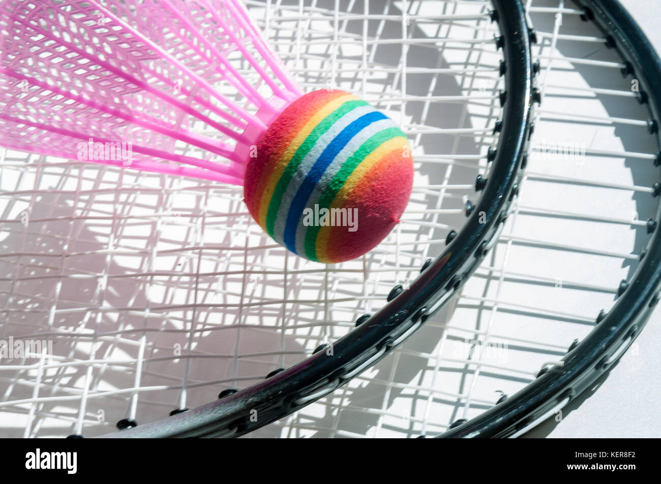 White shuttlecock and badminton rackets lie on a white background Stock ...