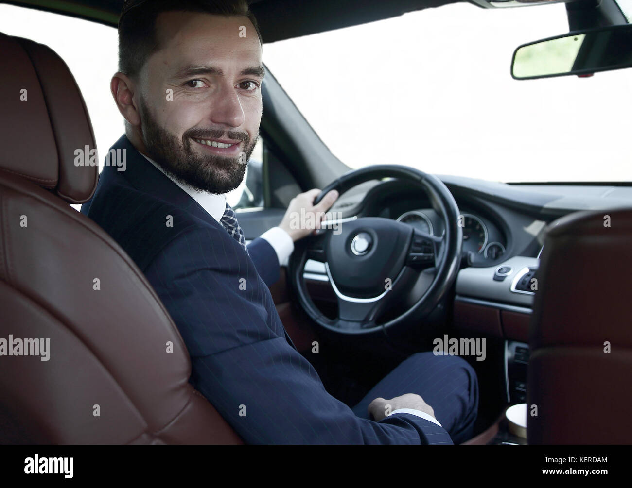 businessman sitting at the wheel of a prestigious car Stock Photo - Alamy