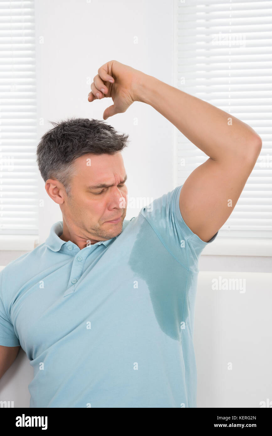 Mature Man Notices His Sweat Under Armpit Stock Photo