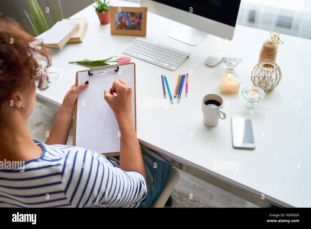 High Angle Of Creative Young Woman Writing Ideas Or Sketching On