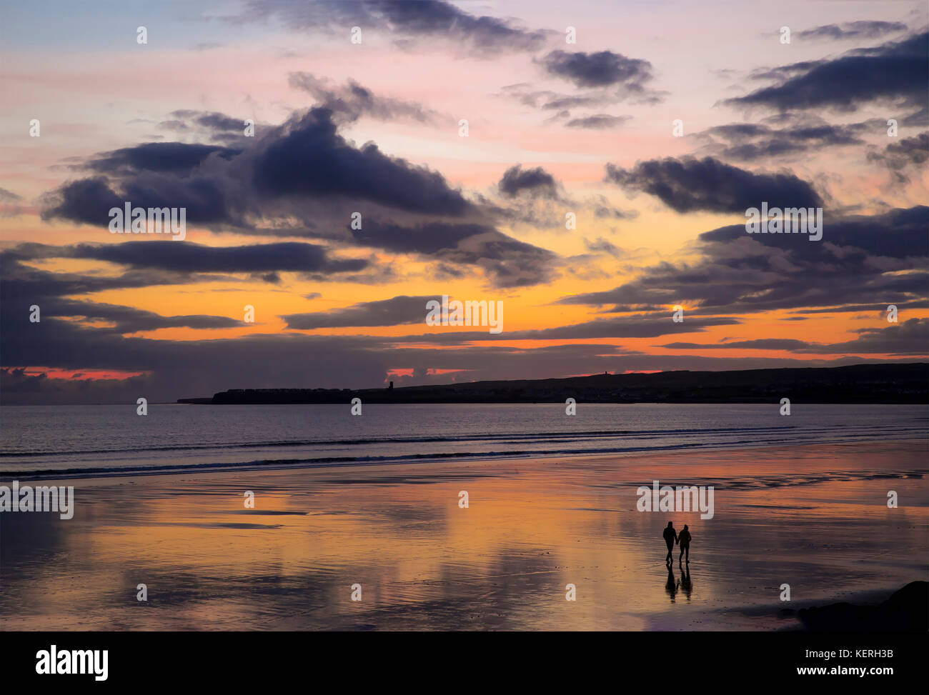 this was a beautiful setting for this couple to take a long romantic walk on the beach at sunset , a great way to end the day..... Stock Photo