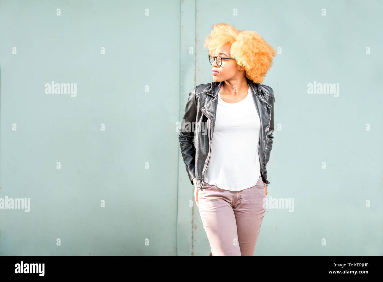 Lifestyle portrait of an african woman on the green background Stock ...