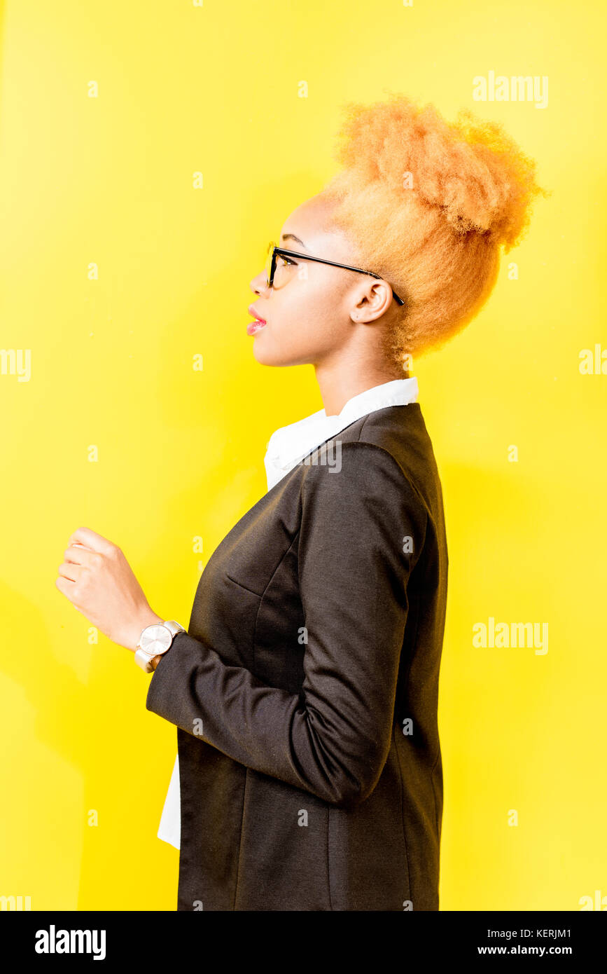 Portrait of an african business lady on the yellow background Stock Photo