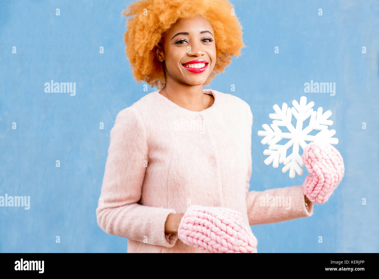 Snowflake Woman Portrait of a woman with artificial snowflake on the blue background ...