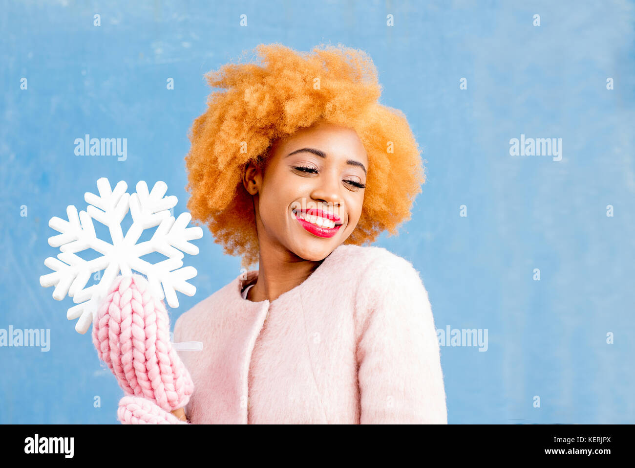 Snowflake Woman Portrait of a woman with artificial snowflake on the blue background ...
