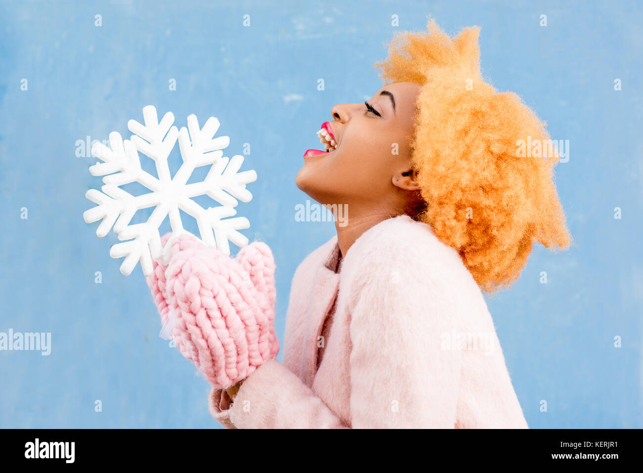 Snowflake Woman Portrait of a woman with artificial snowflake on the blue background ...