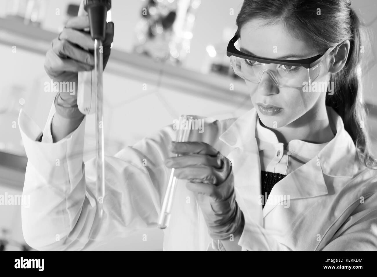 Young scientist pipetting in life science laboratory Stock Photo Alamy