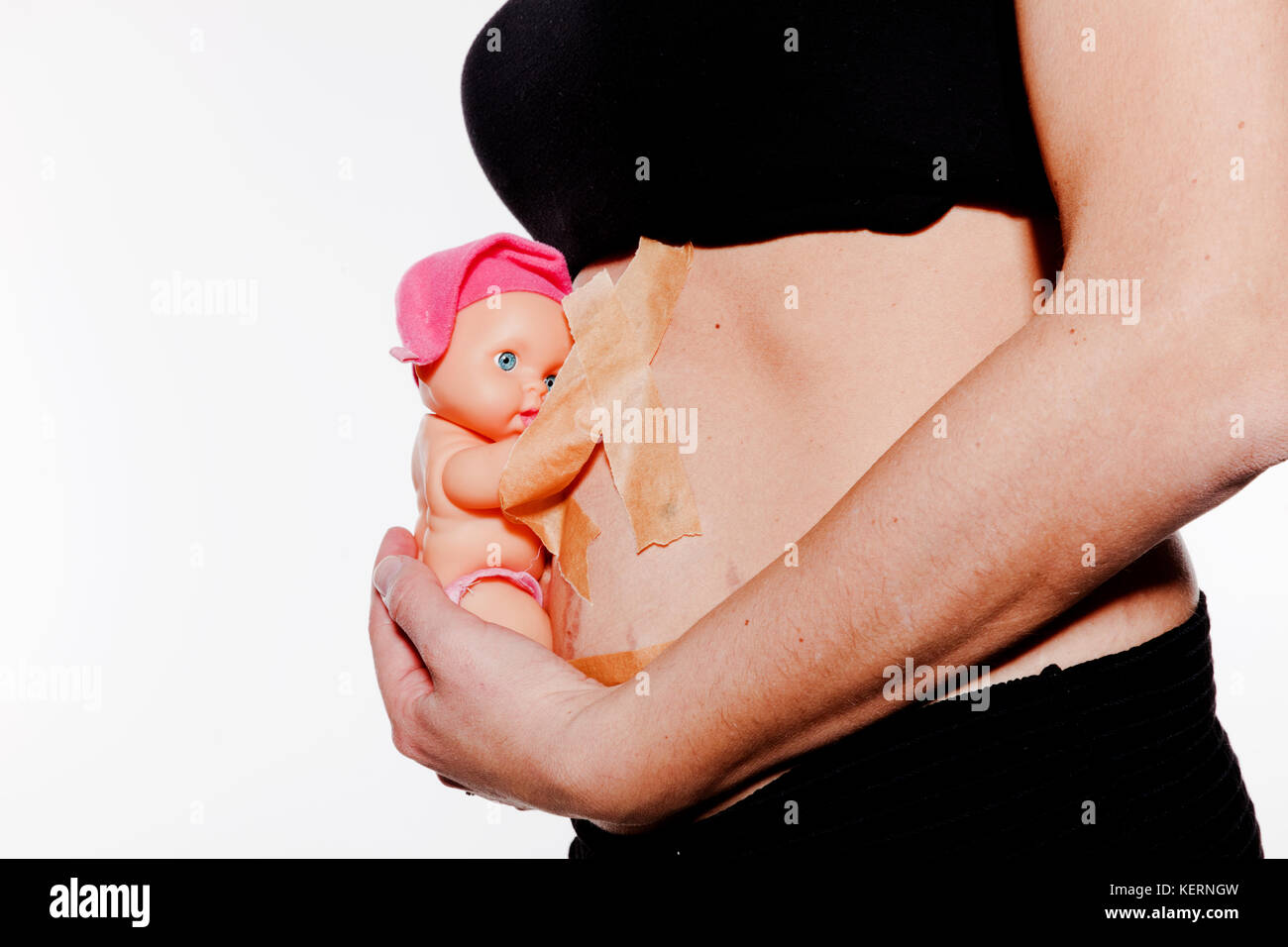 detail of pregnant belly with female doll Stock Photo