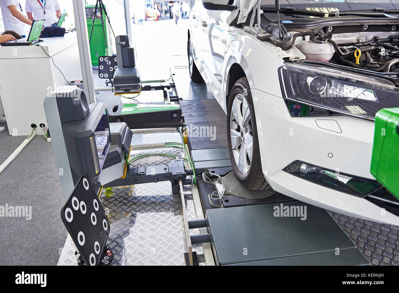 Calibration of the assistant holding camera on the lane on the road in car workshop Stock Photo