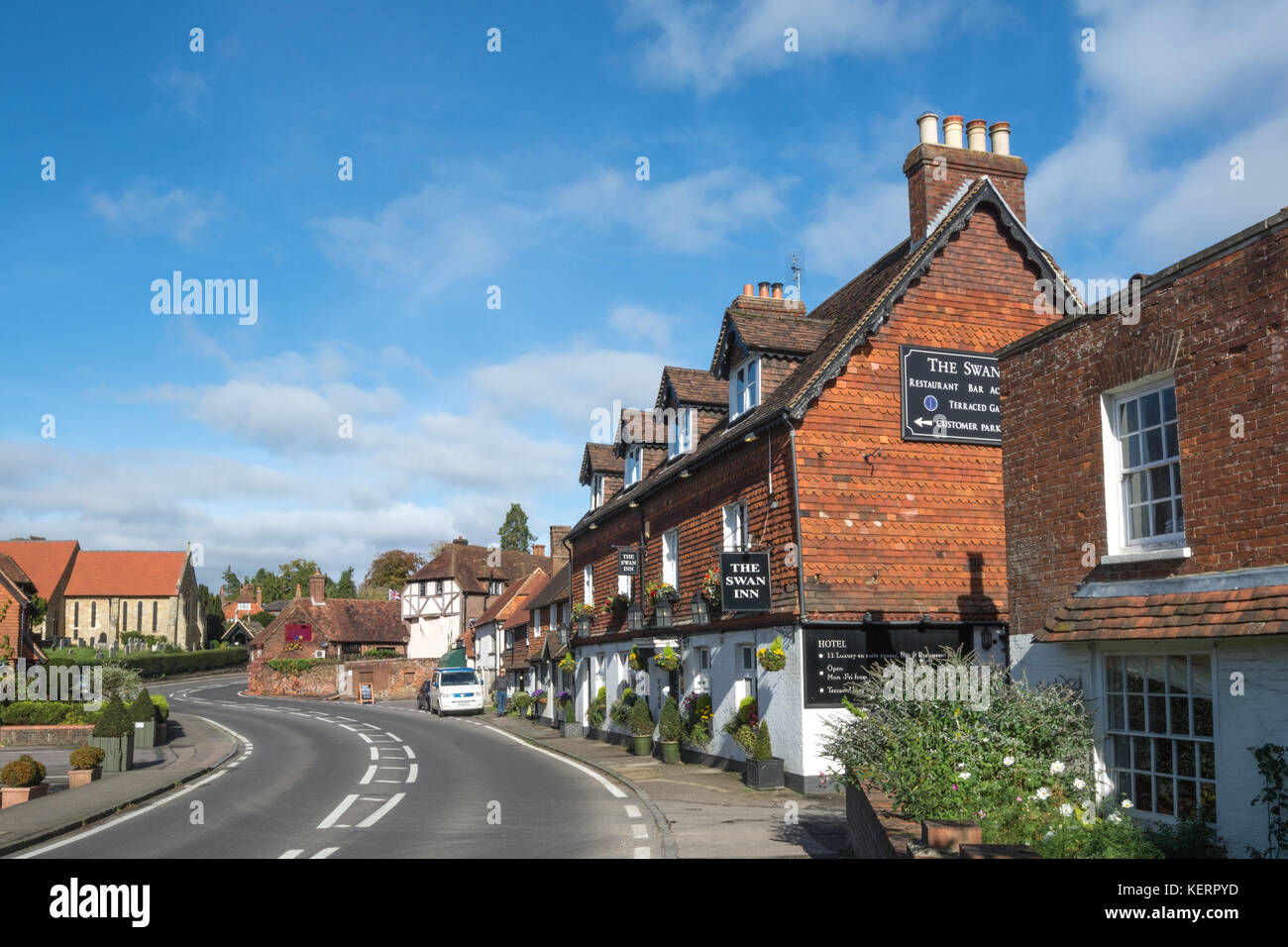 The Swan public house, St Marys church and cottages on the main street in Chiddingfold village in Surrey, UK Stock Photo