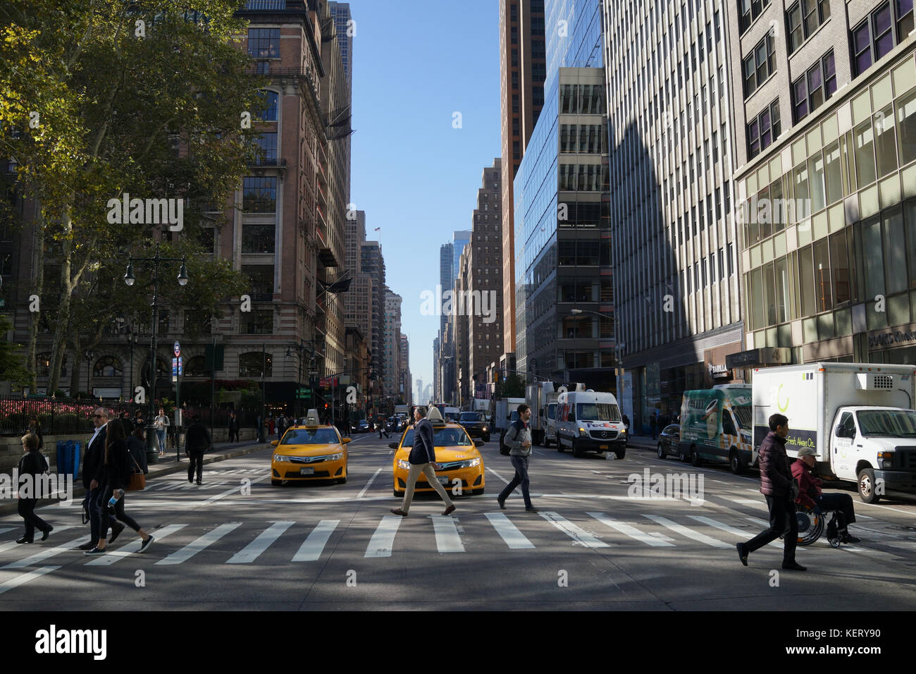 People crossing the street on 6th Avenue (Avenue of the Americas), New York City midtown Stock Photo
