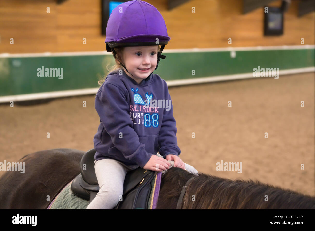 Young Child Horse Riding Lesson Instruction Wearing Purple Hat Helmet Stock Photo