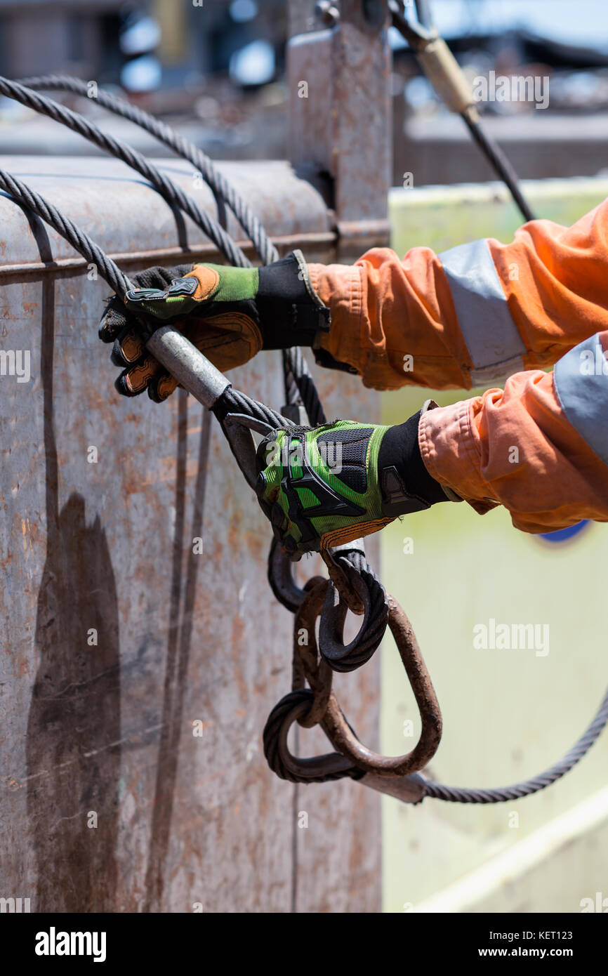 Able seaman is connecting sling. Crane loading operations on dec Stock Photo