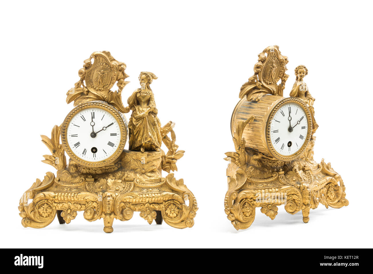 Antique gold colored table clocks on the white background. Stock Photo