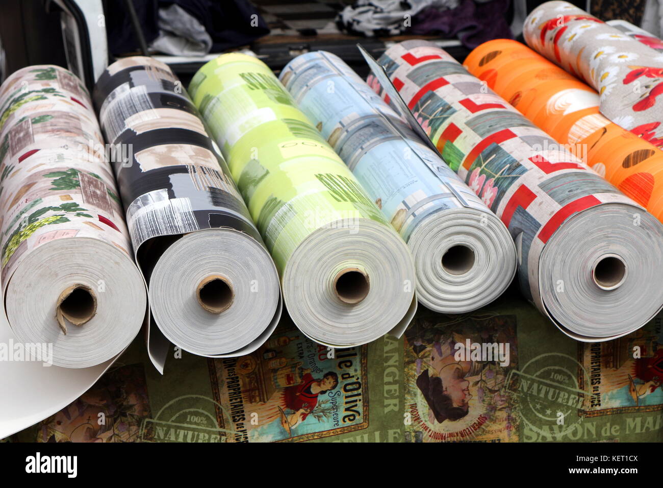 Rolls of vinyl floor covering, or linoleum, for sale at a French street market Stock Photo