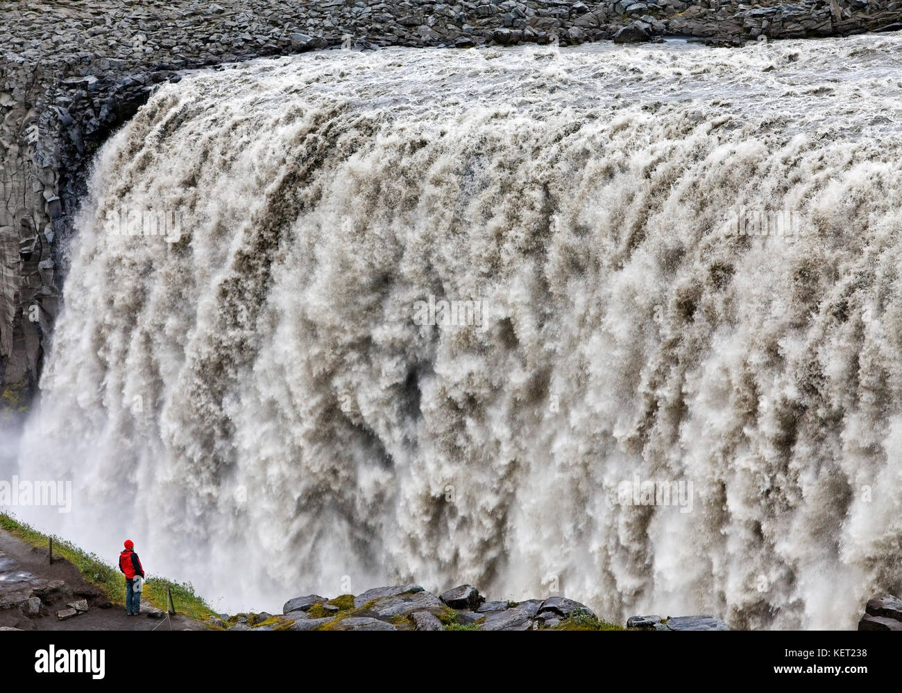 Person at the waterfall Dettifoss, river Jökulsá á Fjöllum, Northern Iceland, Iceland Stock Photo