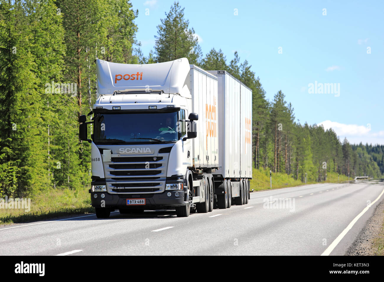 KEURUU, FINLAND - JULY 7, 2017: White Scania G490 cargo truck hauls Finnish Posti Group deliveries along road in Central Finland on a beautiful day of Stock Photo