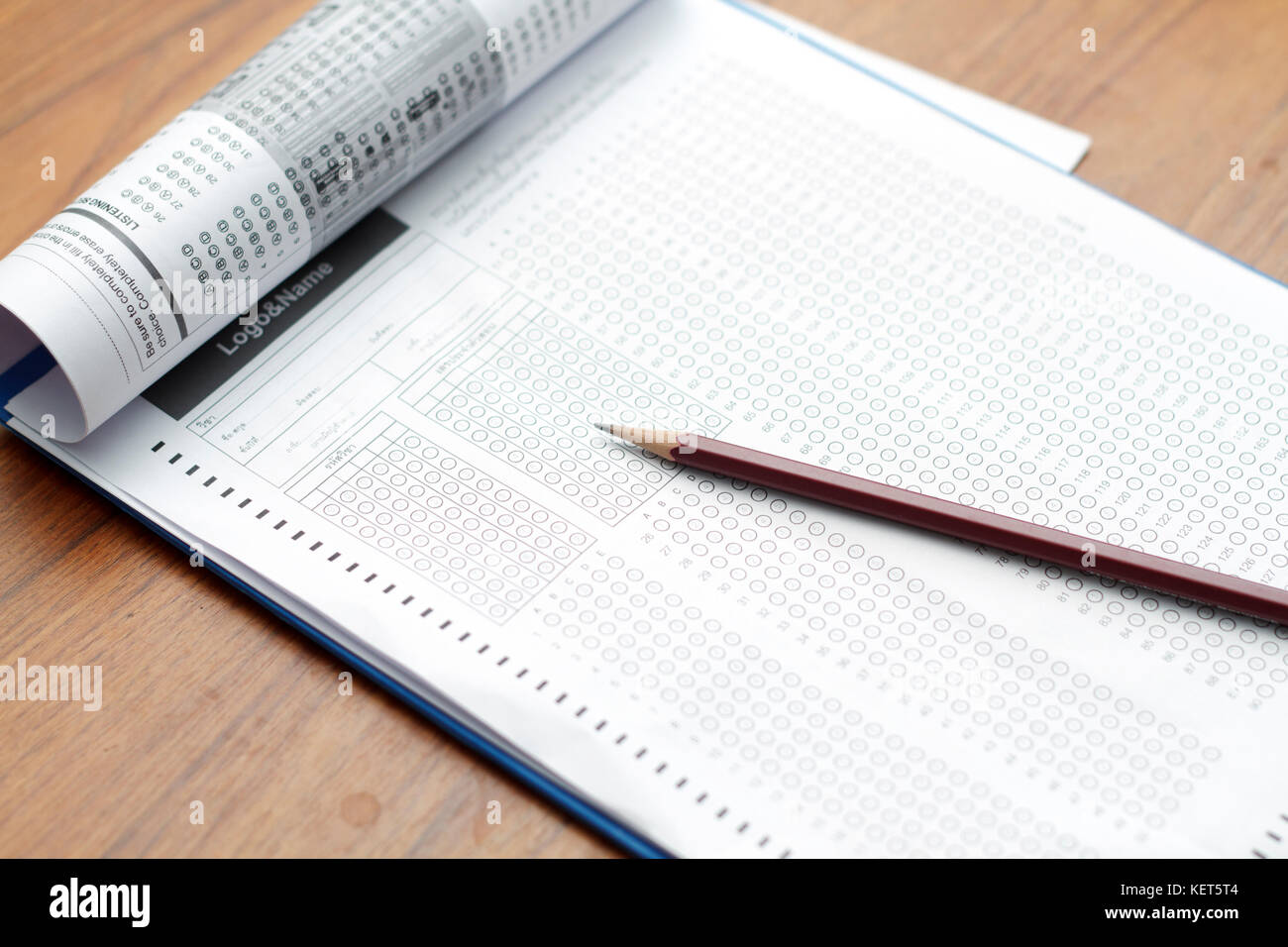 glasses and pencil on Standardized test form with answers bubbled in