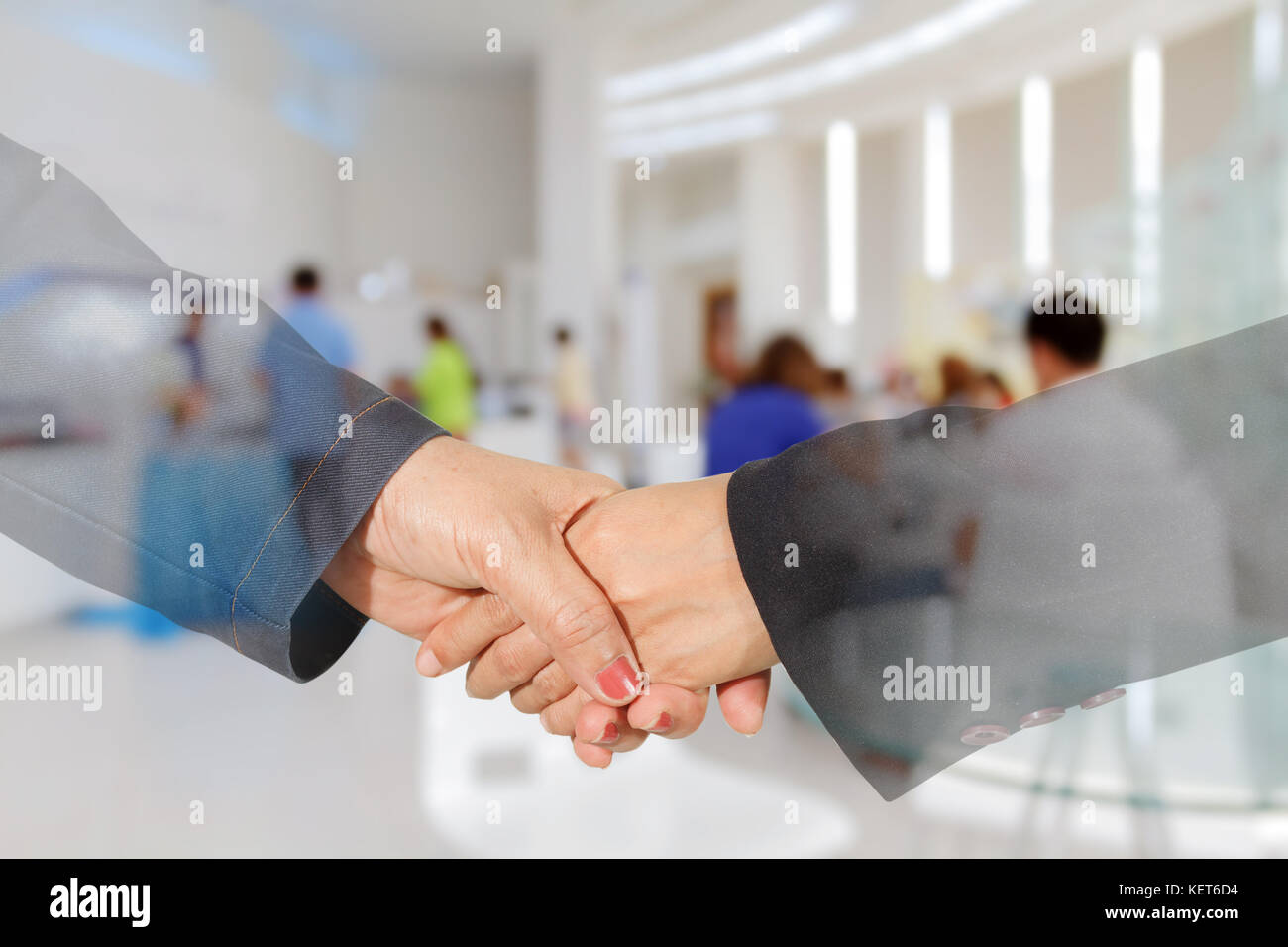Double exposure Businesswoman handshake on business people in office background Stock Photo