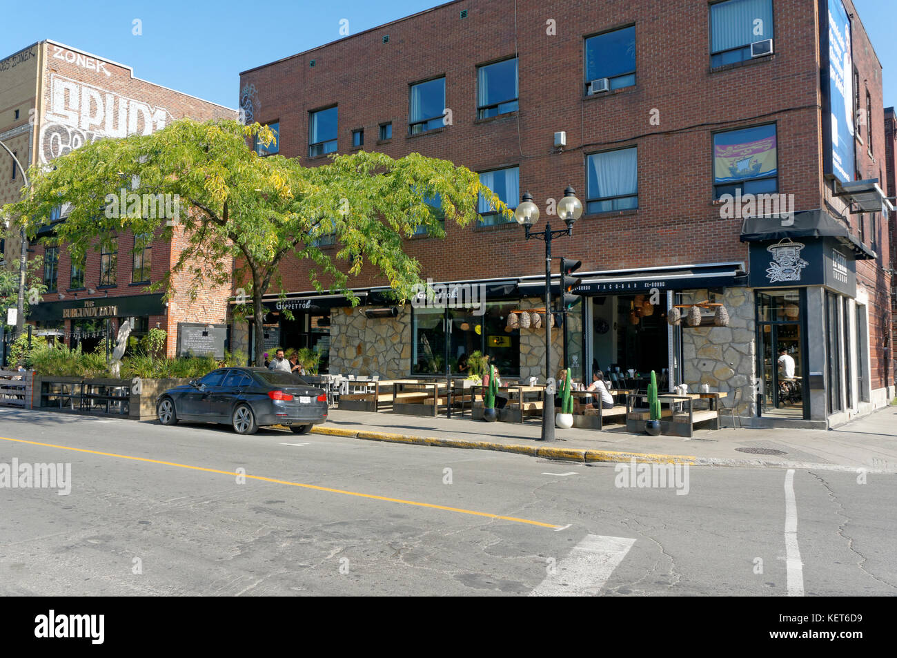 Restaurants with outdoor eating areas in Little Burgundy, Rue Notre-Dame street, Montreal, Quebec, Canada Stock Photo