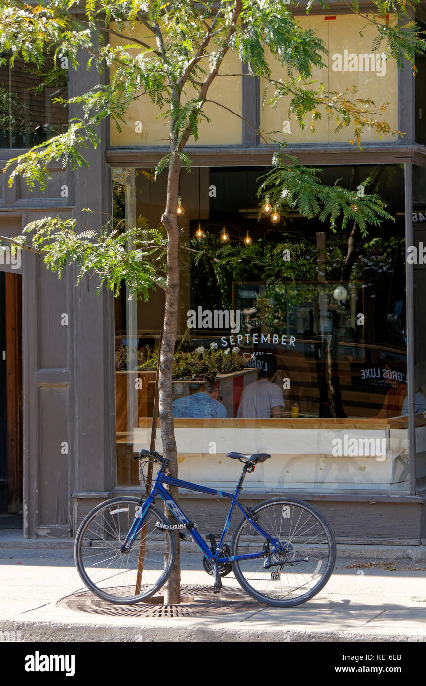 A bicycle parked outside the September Cafe in Little Burgundy, Rue Notre-Dame street, Montreal, Quebec, Canada Stock Photo
