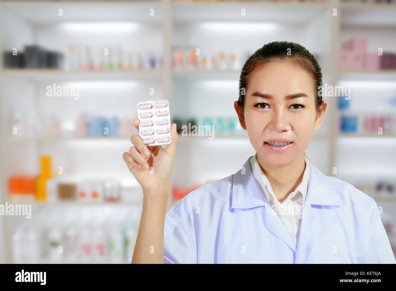 Pharmacist and Doctor woman holding pill in hand , health care and
