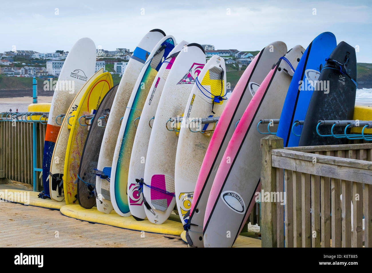 Surfing Fistral Beach - assorted surfboards stacked in a storage rack at Fistral Beach Newquay Cornwall. Stock Photo
