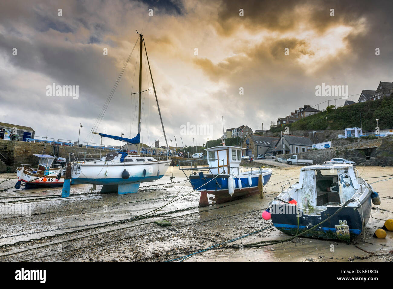 Newquay Harbour Cornwall - evening light over boats tied up at low tide in Newquay harbour. Stock Photo