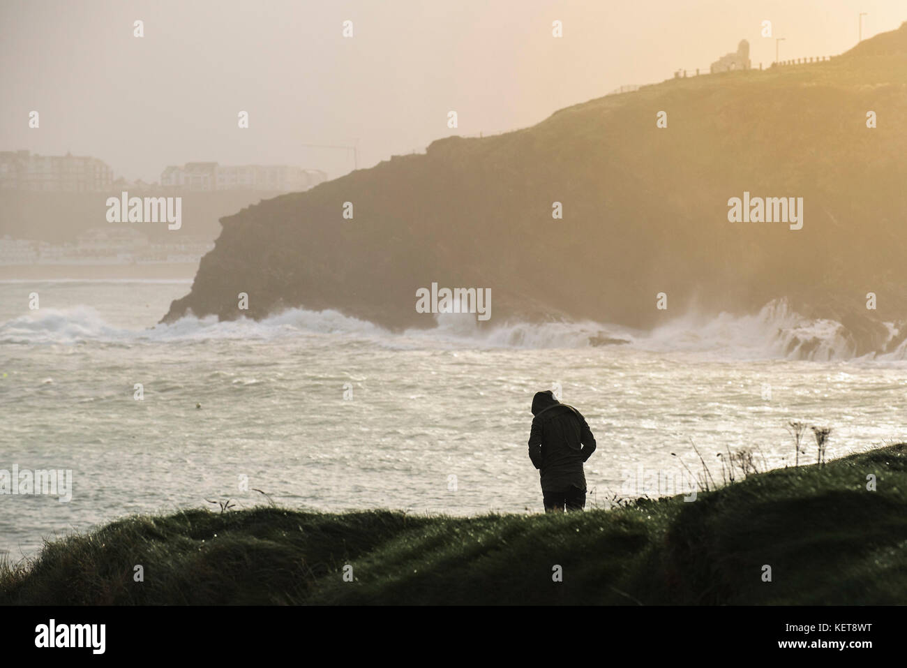 UK Weather - the silhouette of a person standing on the coast during rough weather. Stock Photo