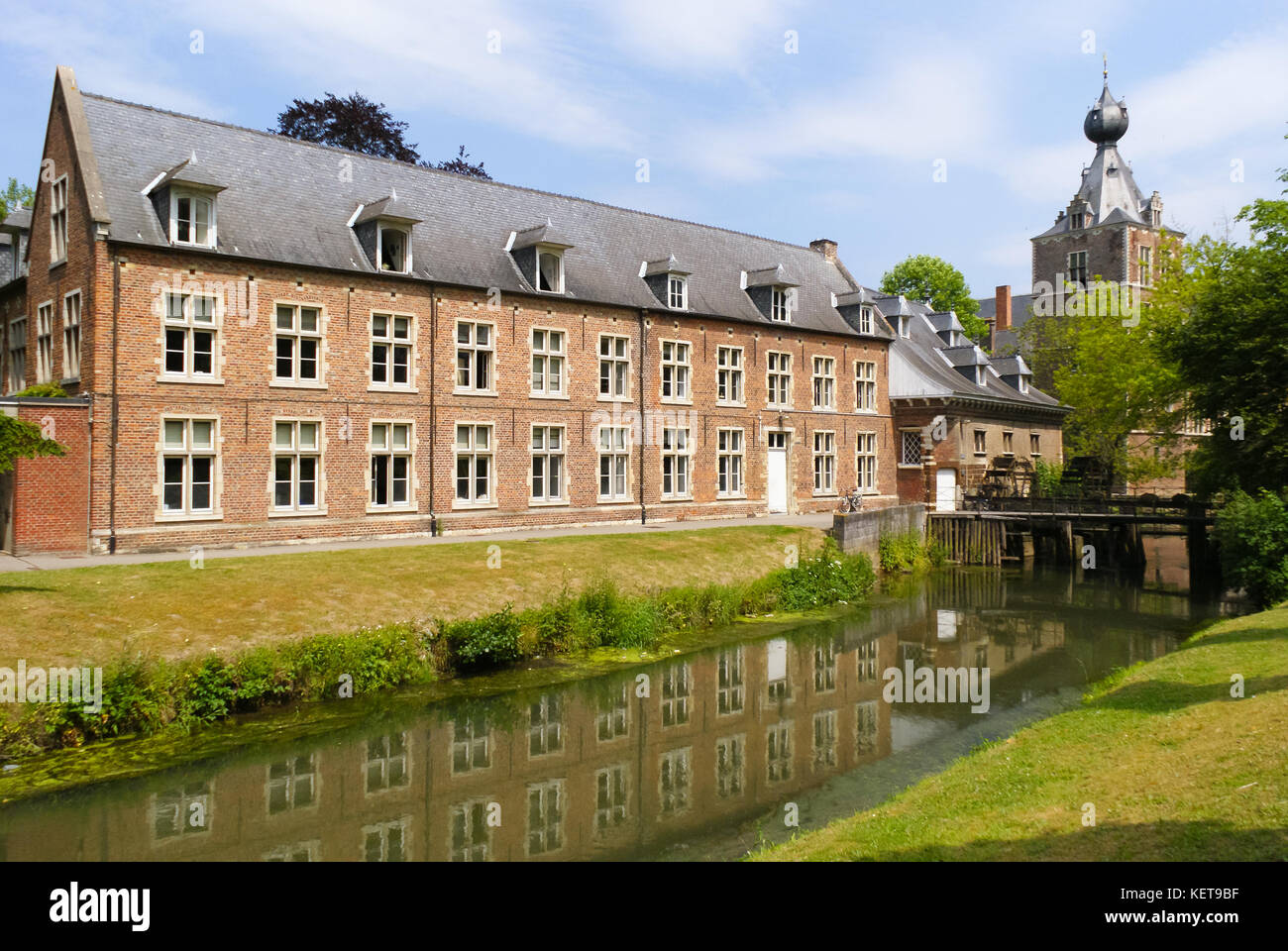 view of the side wing of Arenberg castle with a watermill at Leuven Belgium Stock Photo