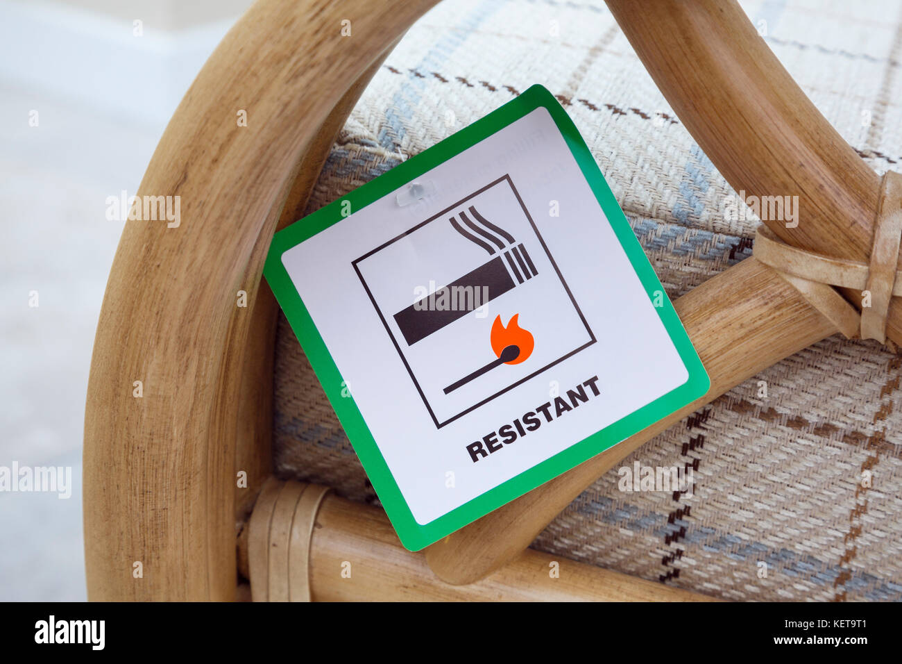 Fire Resistant and Flame Retardent display label on new soft furniture sofa chair resistant to cigarette and match ignition. England, UK, Britain Stock Photo