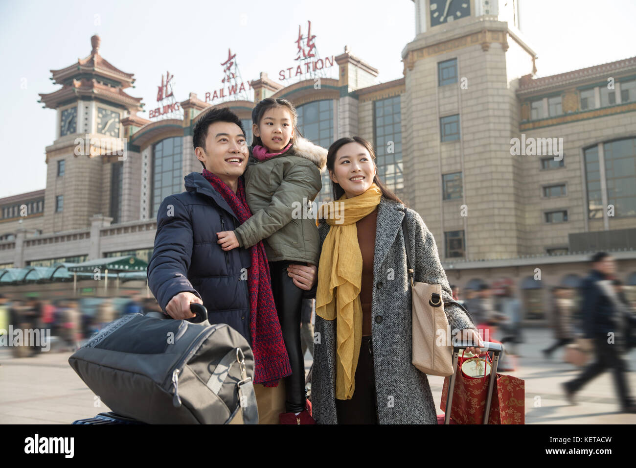 Happy family at the railway station Stock Photo
