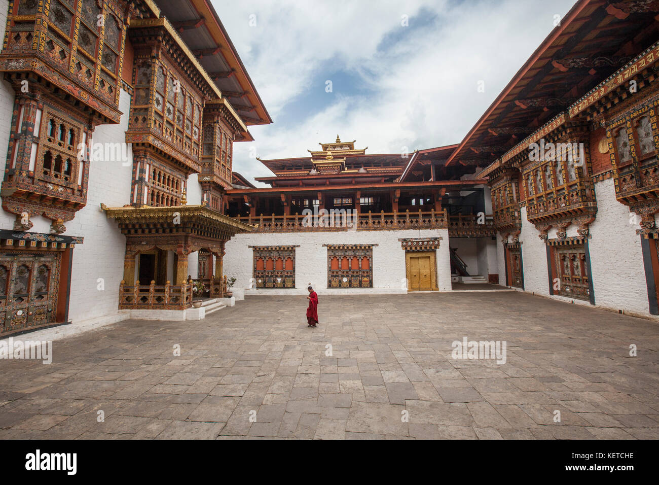 A buddhist monk dressed in red walks in the sacred monastery Thimphu Wangdue Bhutan Asia Stock Photo