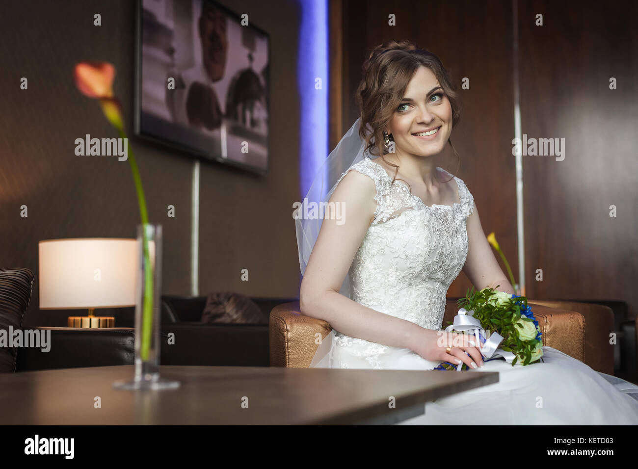 Bride with wedding flowers sitting on the chair Stock Photo - Alamy