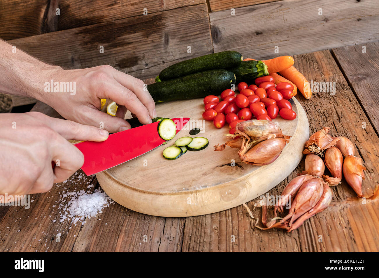 Chef cuts fresh vegetables essential ingredients of typical and healthy Italian cuisine Stock Photo