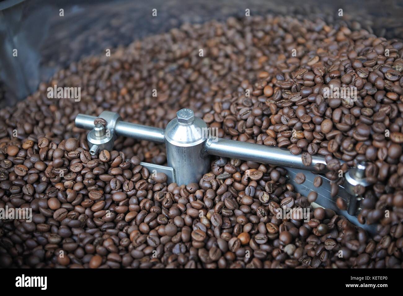 Freshly roasted coffee beans in a coffee roaster Stock Photo Alamy