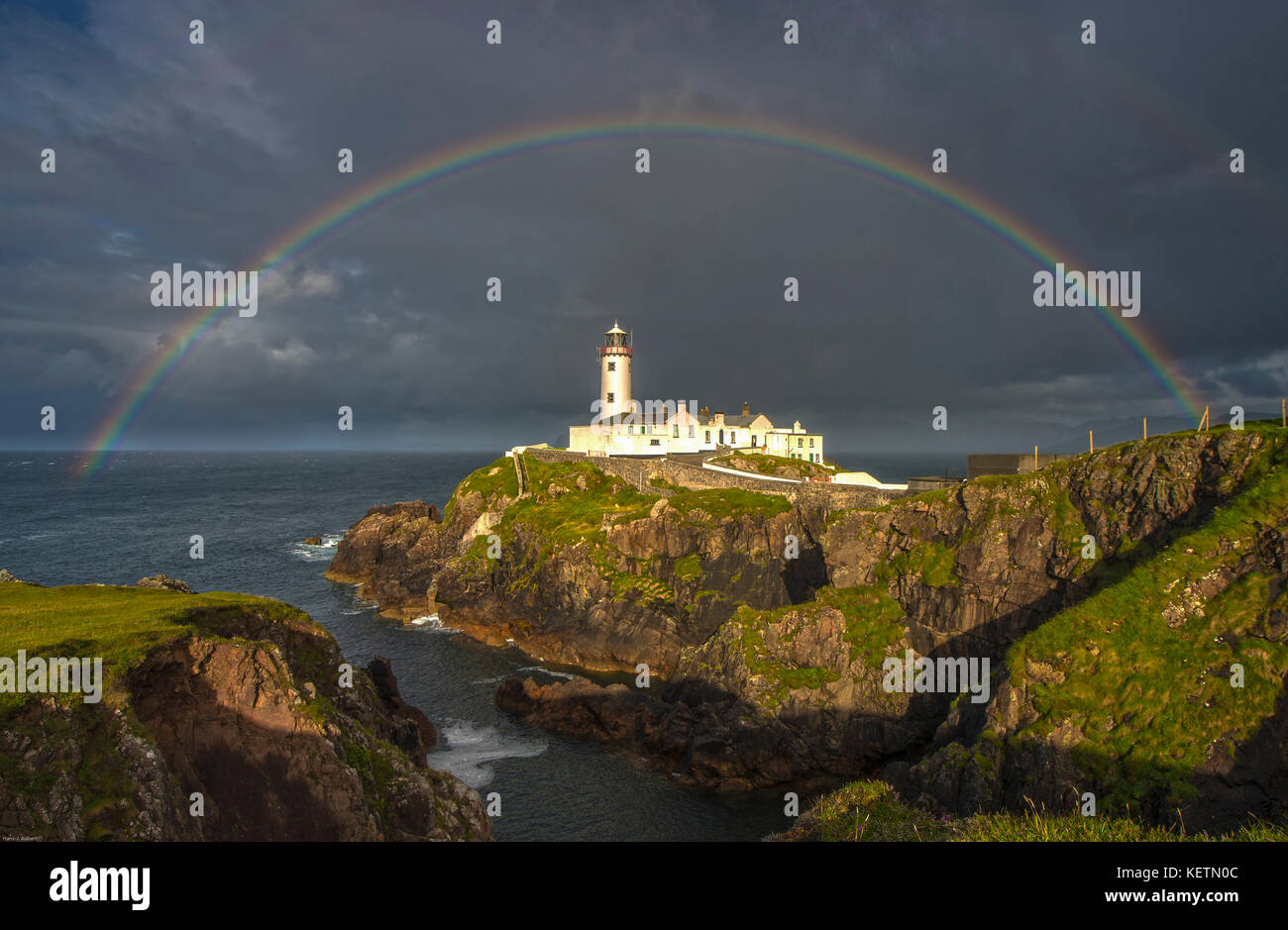 Fanand Head Lighthouse Northern Ireland late afternoon with full rainbow Stock Photo
